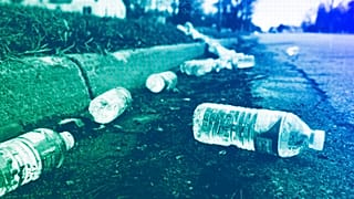 A broken case of water lays along the street near a water station in Flint, MI, February 2016