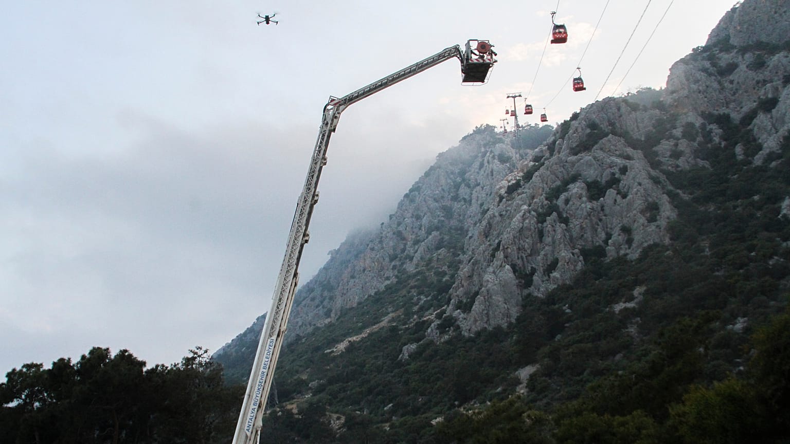 A rescue team work with passengers of a cable car transportation systems outside Antalya, southern Turkey, April, Friday 12, 2024. 