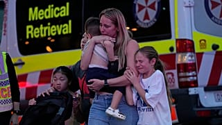 People are led out from the Westfield Shopping Centre where multiple people were stabbed in Sydney, Saturday, April 13, 2024. 