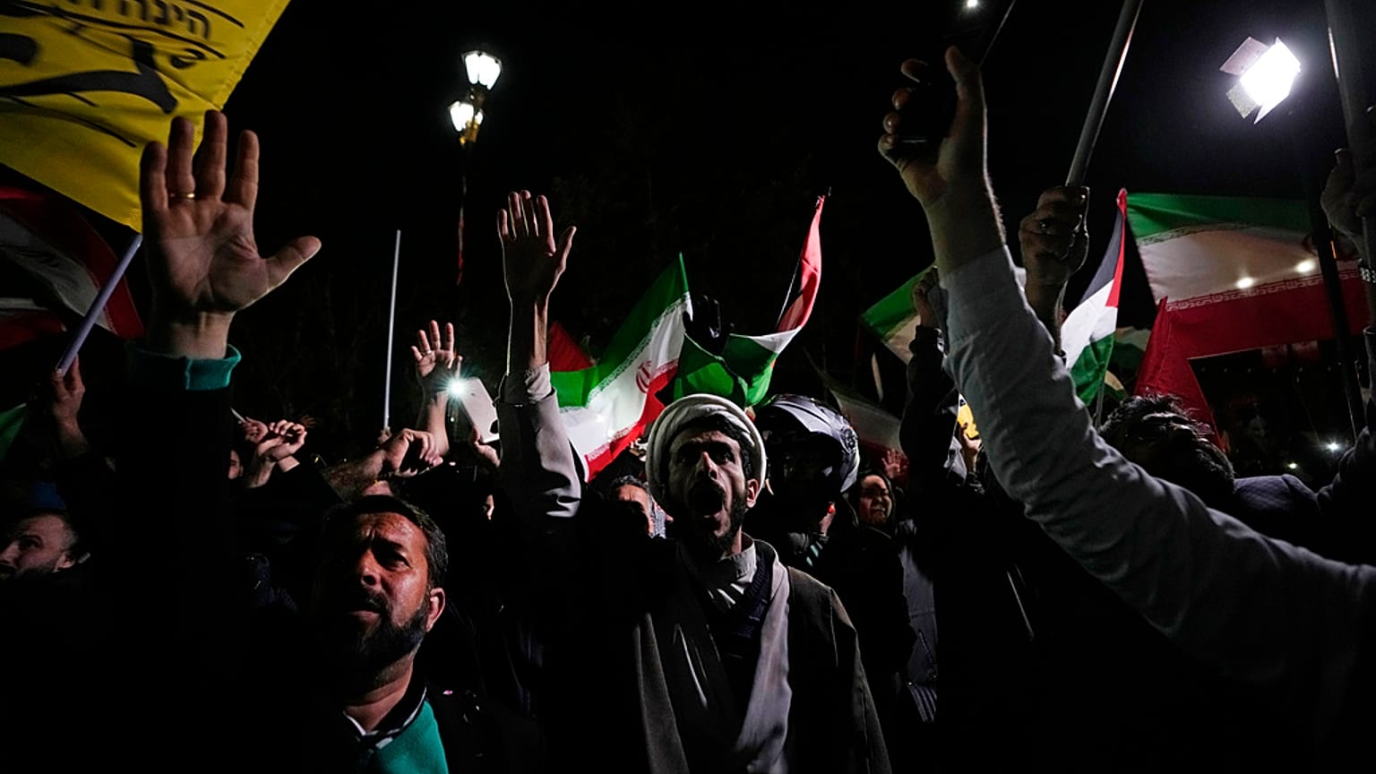 Iranian demonstrators chant slogans during an anti-Israeli gathering in front of the British Embassy in Tehran, Iran, early Sunday, April 14, 2024.