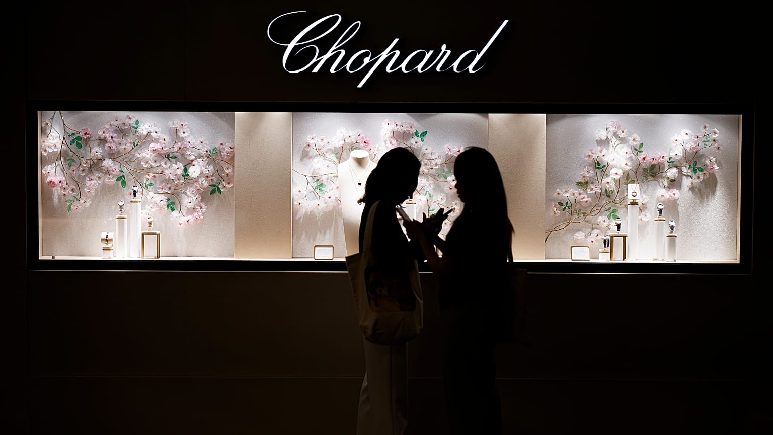 Two women stand in front of Chopard's booth at Watches and Wonders Geneva 2024.