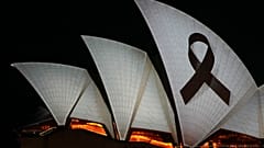 Sydney Opera House is illuminated with a black ribbon Monday, April 15, 2024, as part of the national day of mourning following stabbing deaths of several people at a shop