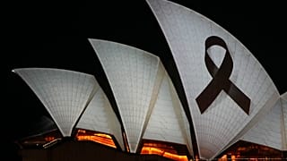 Sydney Opera House is illuminated with a black ribbon Monday, April 15, 2024, as part of the national day of mourning following stabbing deaths of several people at a shop