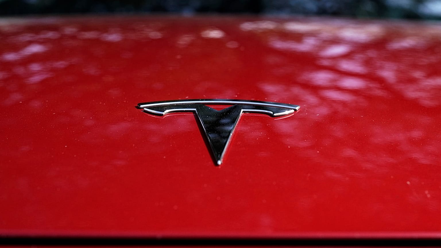 A Tesla logo is seen on a vehicle on display in Austin, Texas, Feb. 22, 2023. 