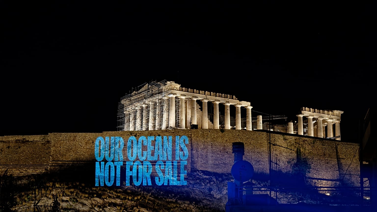 Greenpeace Greece activists project a message reading: 'Our Ocean Is Not For Sale' onto the Acropolis Hill.