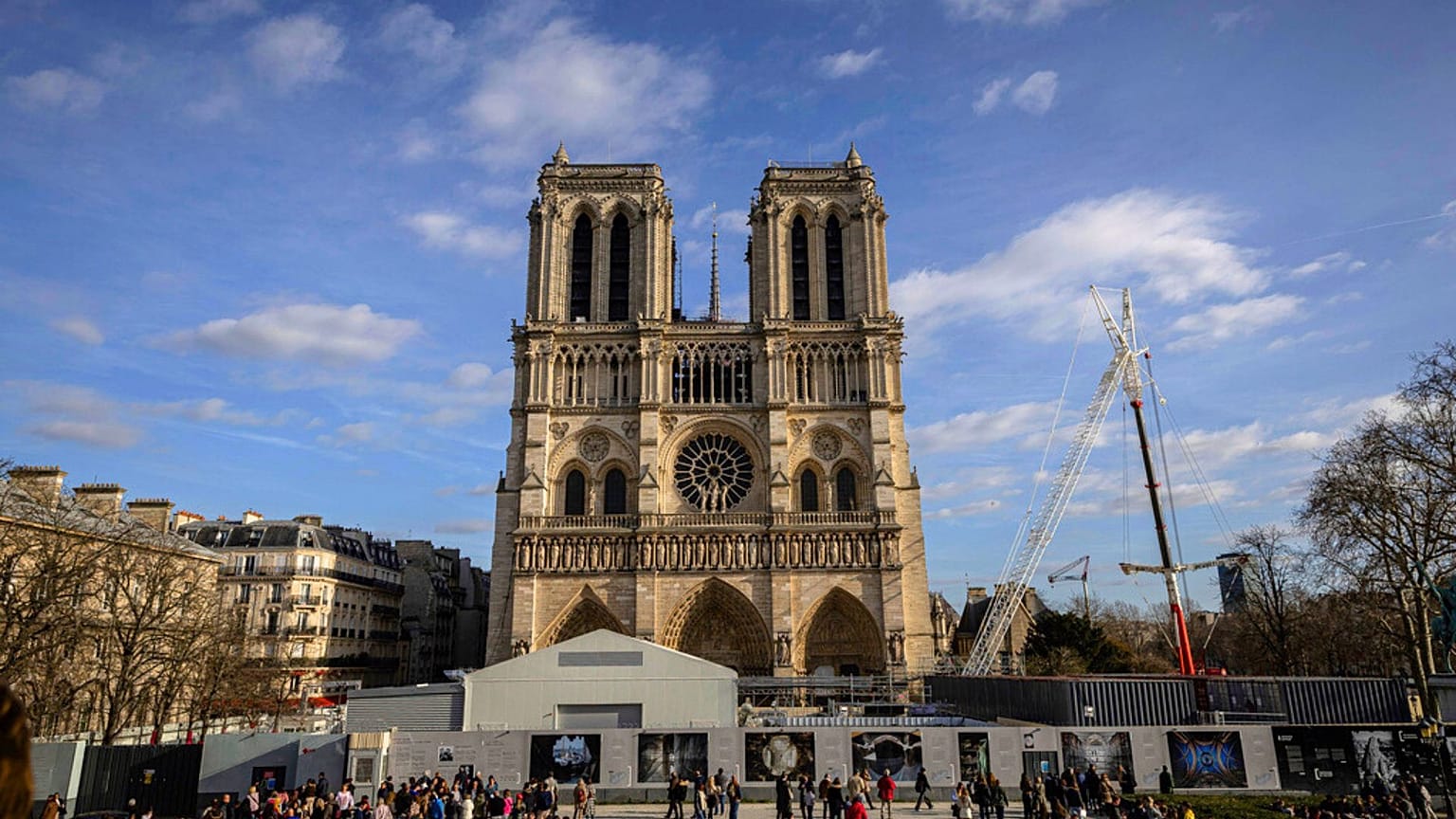 Scaffolding is being removed around the spire of Notre Dame de Paris cathedral, showing the rooster and the cross, in Paris, France, Saturday, Feb. 17, 2024.
