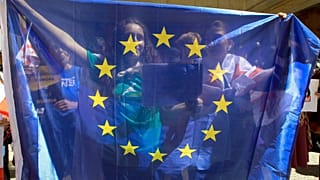 Protesters hold a EU flag as they gather outside the parliament building in Tbilisi, Georgia, April 16, 2024.