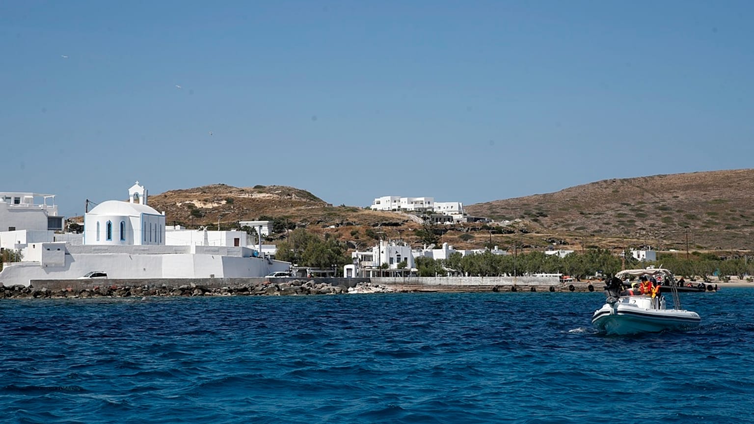 FILE- Medical staff in a dinghy leaves from the Aegean Sea island of Milos to Sikinos island, Greece, Monday, May 25, 2020.
