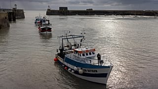 French trawlers arrive in the port of Granville, Normandy, after fishing.