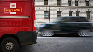 A car overtakes a Royal Mail delivery van, in Westminster in London, Thursday, Jan. 25, 2024.