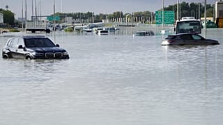 Verlassene Fahrzeuge auf einer überfluteten Straße in Dubai, Vereinigte Arabische Emirate.