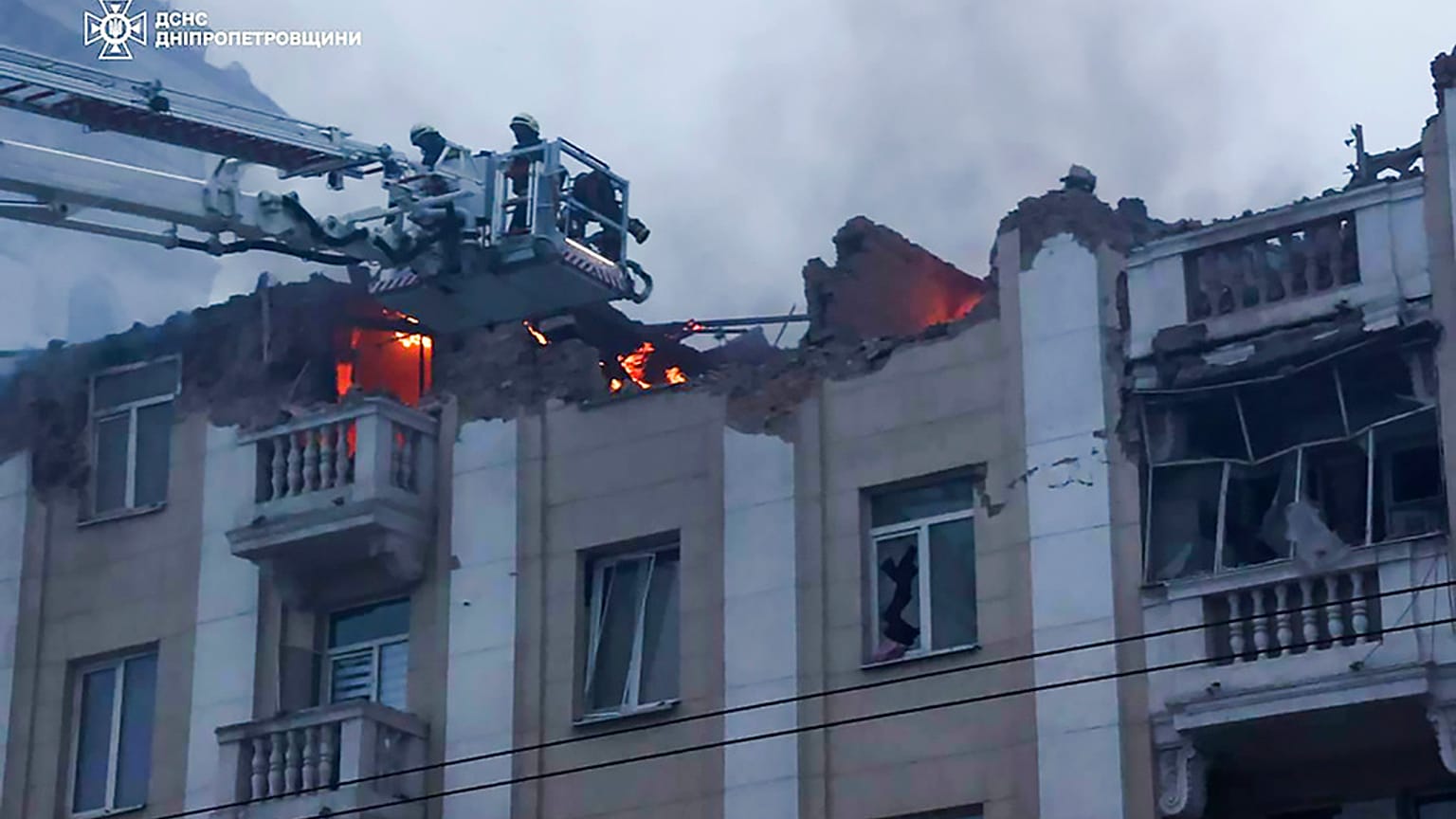 In this photo provided by the Ukrainian Emergency Service, rescuers work on the scene of a building damaged after a Russian attack in Dnipro, Ukraine, Friday, April 19, 2024.