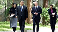 Chinese President Xi Jinping, second from left, and German Chancellor Olaf Scholz, second from right, walk together in Beijing, China, on Tuesday, April 16, 2024. 