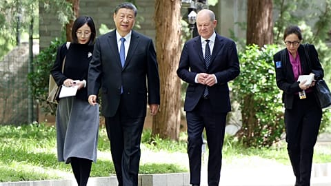 Chinese President Xi Jinping, second from left, and German Chancellor Olaf Scholz, second from right, walk together in Beijing, China, on Tuesday, April 16, 2024. 