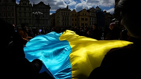 People wave with Ukrainian flag during a demonstration in support of Estonian military strategic plan for Ukraine, Czech Republic, April 21, 2024. 