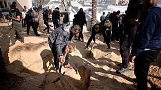 Palestinians dig graves to bury their relatives who were killed in the Israeli bombardment of the Gaza Strip, at the Nasser hospital in Khan Younis, Monday, Jan. 22, 2024.