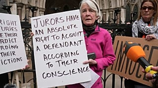 Trudi Warner was accused of contempt for holding a sign reminding jurors of their right to acquit based on conscience.