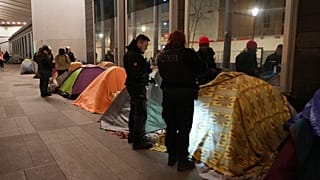 Police officers evicted migrants from a makeshift camp in Paris a few steps from the Seine River (AP Photo/Nicolas Garriga) 