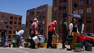 Residents line up to collect water from a truck during water rationing in La Calera, on the outskirts of Bogota, Colombia.