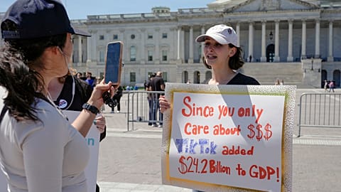A TikTok content creator, speaks to reporters outside the U.S. Capitol.