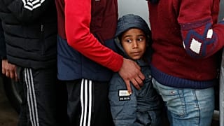 Migrants wait in line for blankets close to the Turkish-Greek border.