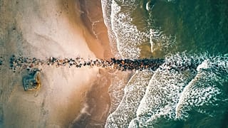 Ocean waves crash in Blavand Strand in Denmark, one of the best hidden destinations on the list