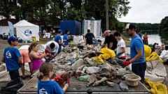 Volunteers in Hungary clear waste plastic from a river.