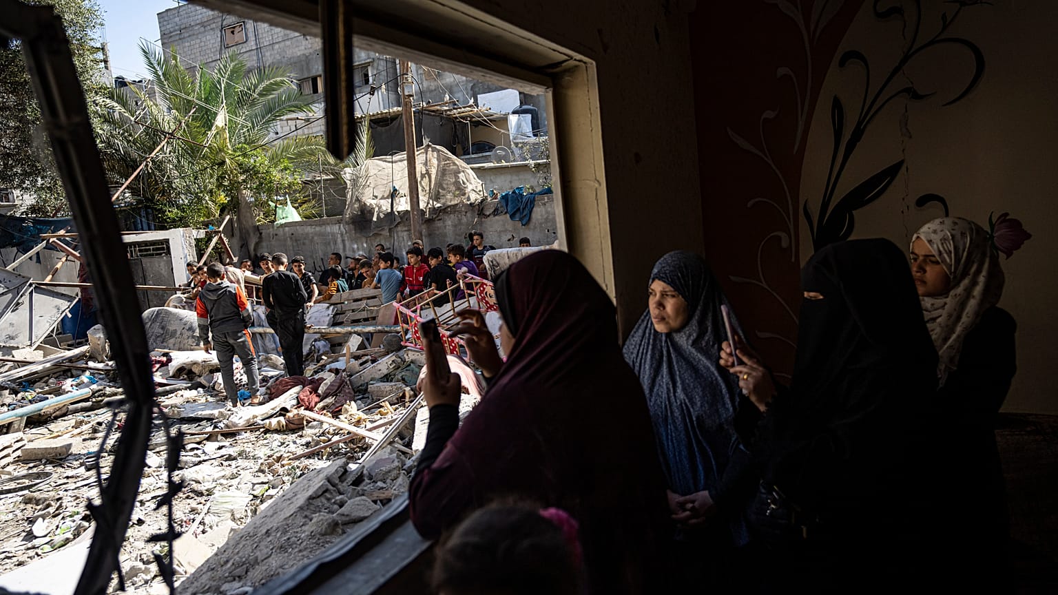 Members of the Abu Draz family inspect their house after it was hit by an Israeli airstrike in Rafah, southern Gaza