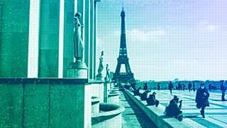 People walk near the Eiffel Tower in Paris, March 2021