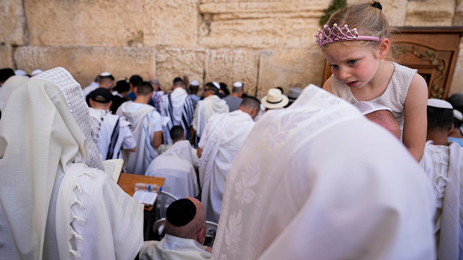 Covered in prayer shawls, Jewish men of the Cohanim Priestly caste participate in a blessing Jerusalem's Old City, Thursday, April 25, 2024.