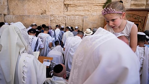 Covered in prayer shawls, Jewish men of the Cohanim Priestly caste participate in a blessing Jerusalem's Old City, Thursday, April 25, 2024.