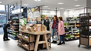 An employee and customers at Sweden's alcohol retail monopoly, Systembolaget