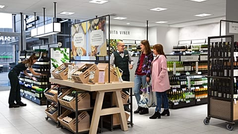 An employee and customers at Sweden's alcohol retail monopoly, Systembolaget