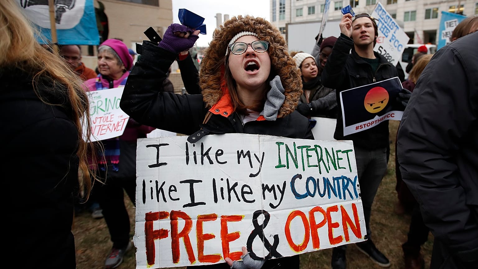 Lindsay Chestnut of Baltimore holds a sign that reads "I like My Internet Like I Like my Country: Free & Open".