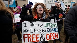 Lindsay Chestnut of Baltimore holds a sign that reads "I like My Internet Like I Like my Country: Free & Open".