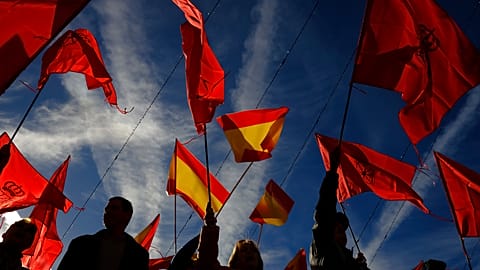 Demonstrators waves Spanish and Navarre flags as they protest against the amnesty at Plaza del Castillo square, in Pamplona, northern Spain, Saturday, Nov. 18, 2023. 