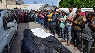 Mourners pray over the bodies of Palestinians who were killed in an Israeli airstrike in Nuseirat, at the Al Aqsa hospital in Gaza Strip, Saturday, April 27, 2024