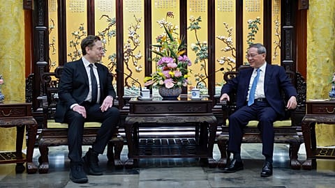 In this photo released by Xinhua News Agency, visiting Tesla founder and CEO Elon Musk, left, meets with Chinese Premier Li Qiang in Beijing, Sunday, April 28, 2024. 