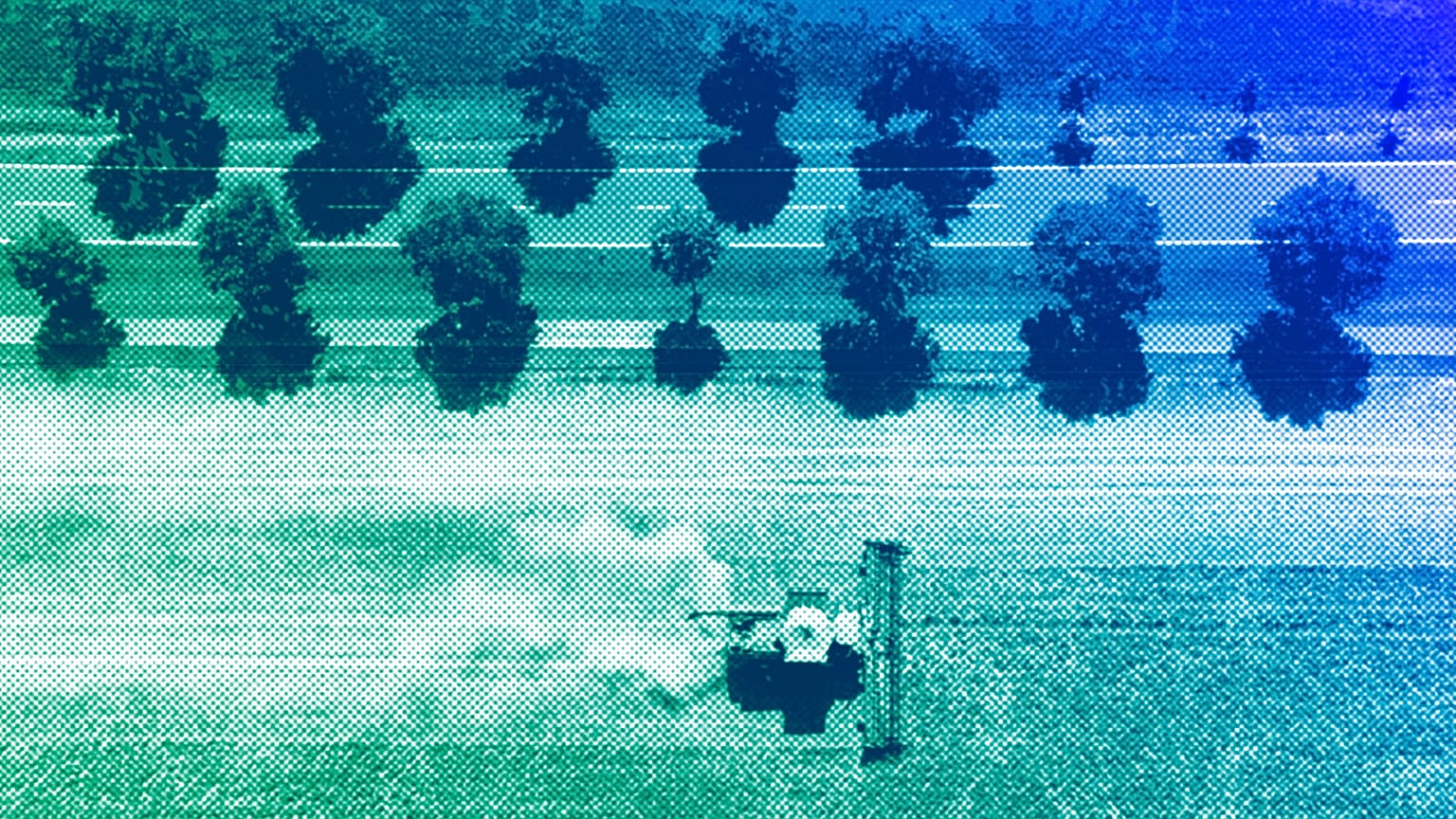 A farmer harvests a grain field near Wernigerode, Germany, August 2023