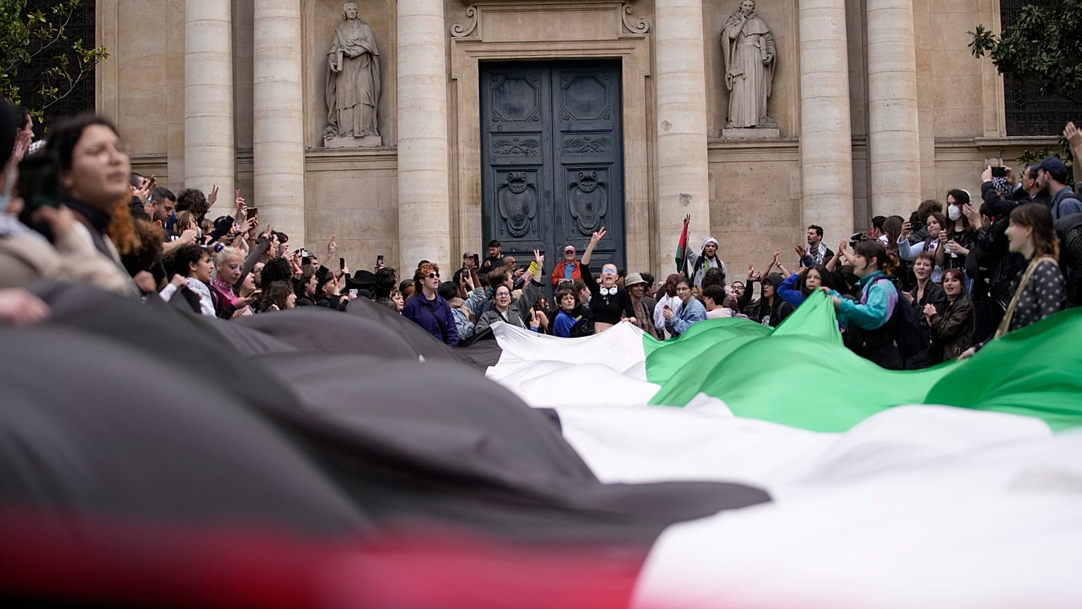 Studenten demonstrieren vor der Universität Sorbonne mit einer riesigen palästinensischen Flagge, 29. April 2024 