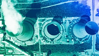 Vapour emerges from a cooling tower at a power plant outside the northern city of Kozani, June 2022