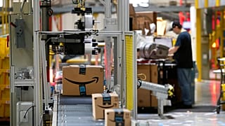 File photo of packages pass through a scanner at an Amazon centre