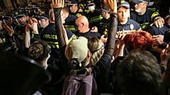 Ein Demonstrant gestikuliert, während er während einer Demonstration gegen das „russische Gesetz“ in der Nähe des Parlamentsgebäudes in Tiflis am 1. Mai 2024 mit der Polizei streitet