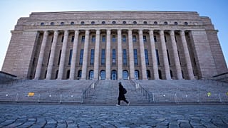 A person walks past Finland's parliament building in Helsinki, 4 April 2023