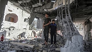 Palestinians stand in the ruins of the Chahine family home, after an overnight Israeli strike in Rafah, southern Gaza Strip, Friday, May 3, 2024.