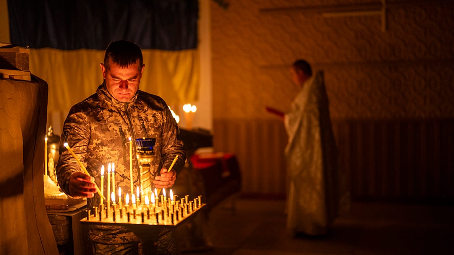 An Ukrainian serviceman of the 72nd Separate Mechanized Brigade, lights candles during a Christian Orthodox Easter religious service, in Donetsk region, Ukraine, 4 May, 2024.