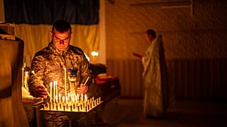 An Ukrainian serviceman of the 72nd Separate Mechanized Brigade, lights candles during a Christian Orthodox Easter religious service, in Donetsk region, Ukraine, 4 May, 2024.