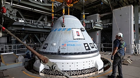 In this photo provided by NASA, the Boeing Starliner spacecraft is lifted at the Vertical Integration Facility at Space Launch Complex-41 at Cape Canaveral Space Force Station