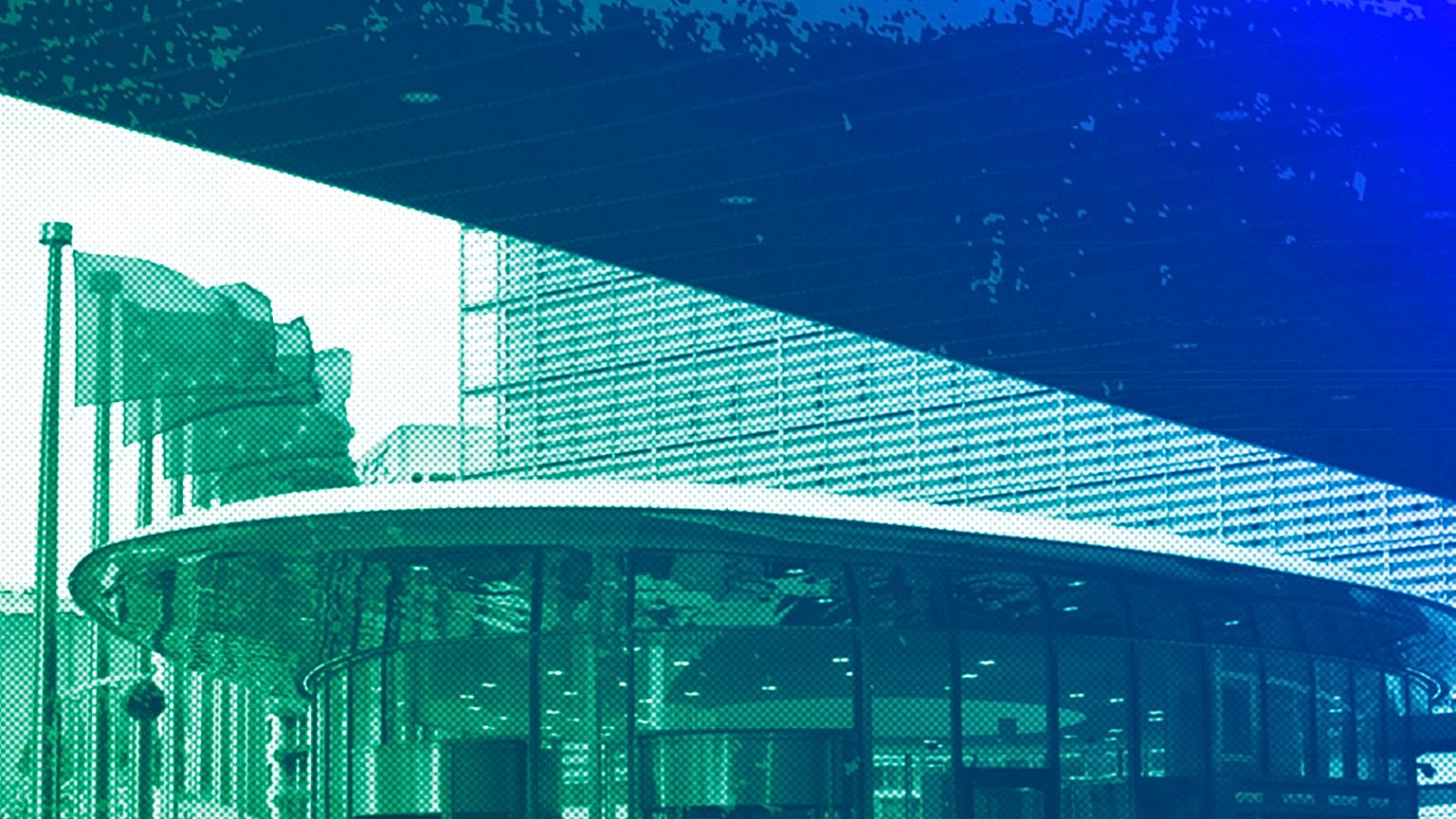 European Union flags flap in the wind outside European Commission headquarters in Brussels, April 2024