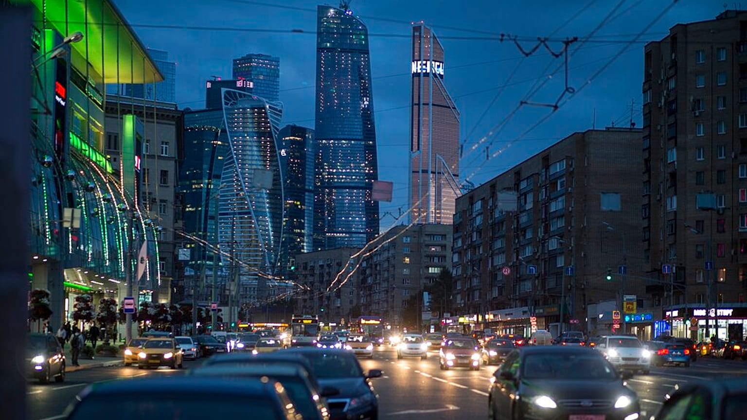 Traffic fills the multi-lane highway, along a main thoroughfare in Moscow, with the modern city skyscrapers illuminating the skyline in Moscow, Russia, Friday, July 8, 2016.